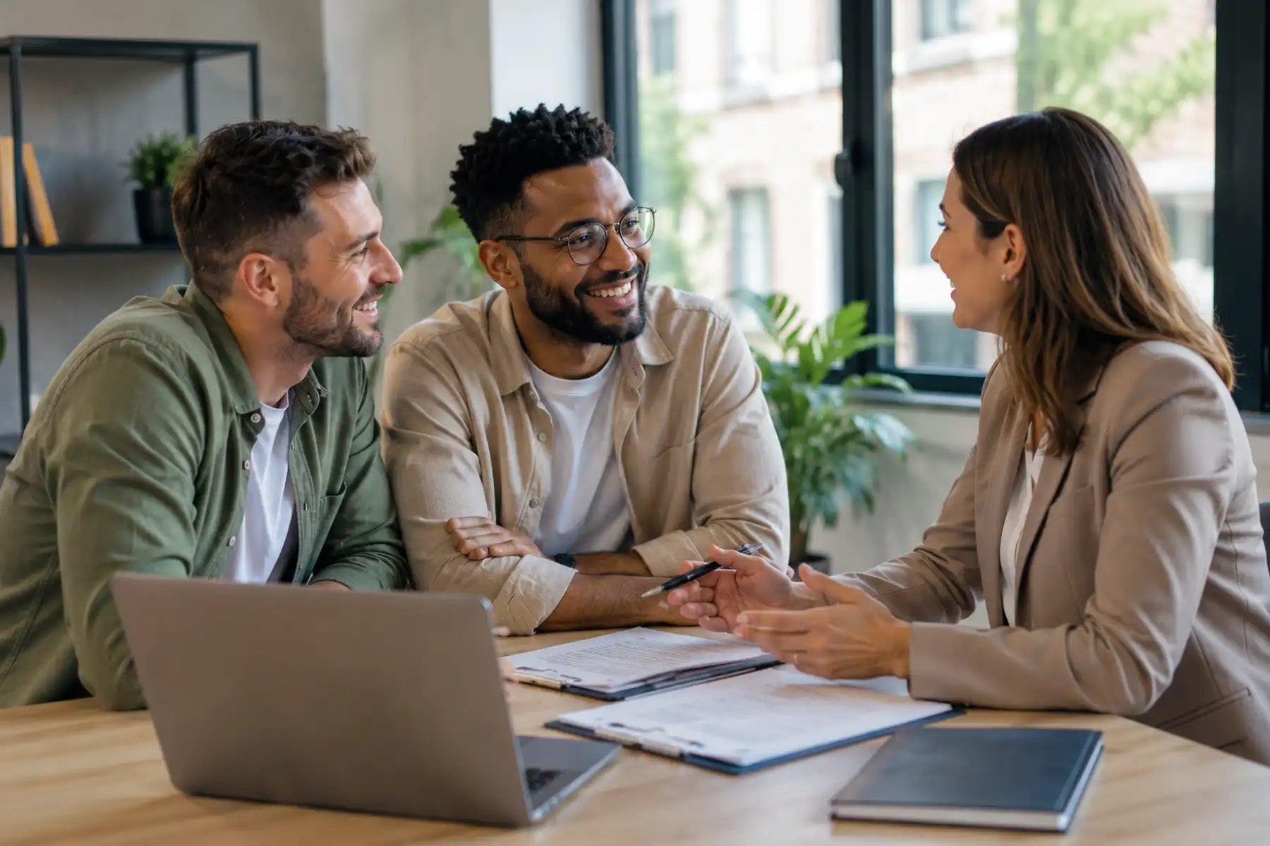 First-time buyer couple meeting with a mortgage adviser to review mortgage documents.