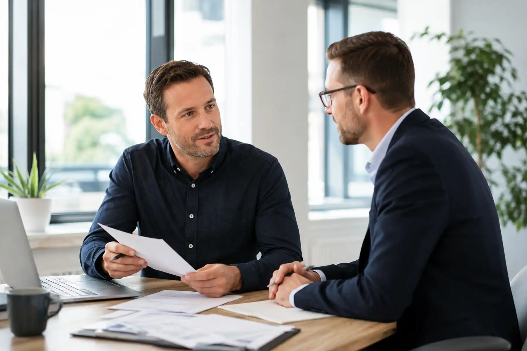 Contractor reviewing mortgage advice with a mortgage adviser.