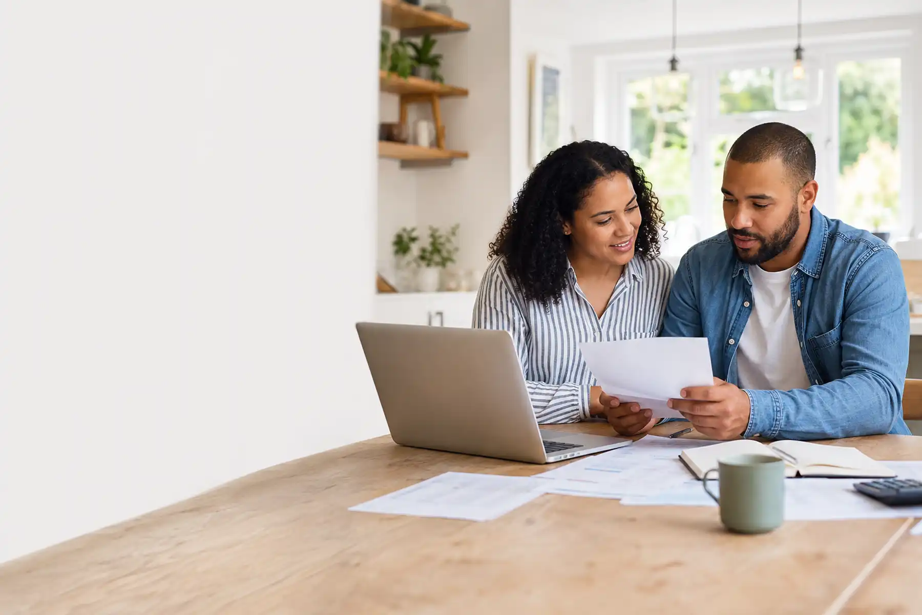 Homeowners reviewing mortgage paperwork together in a modern UK home.